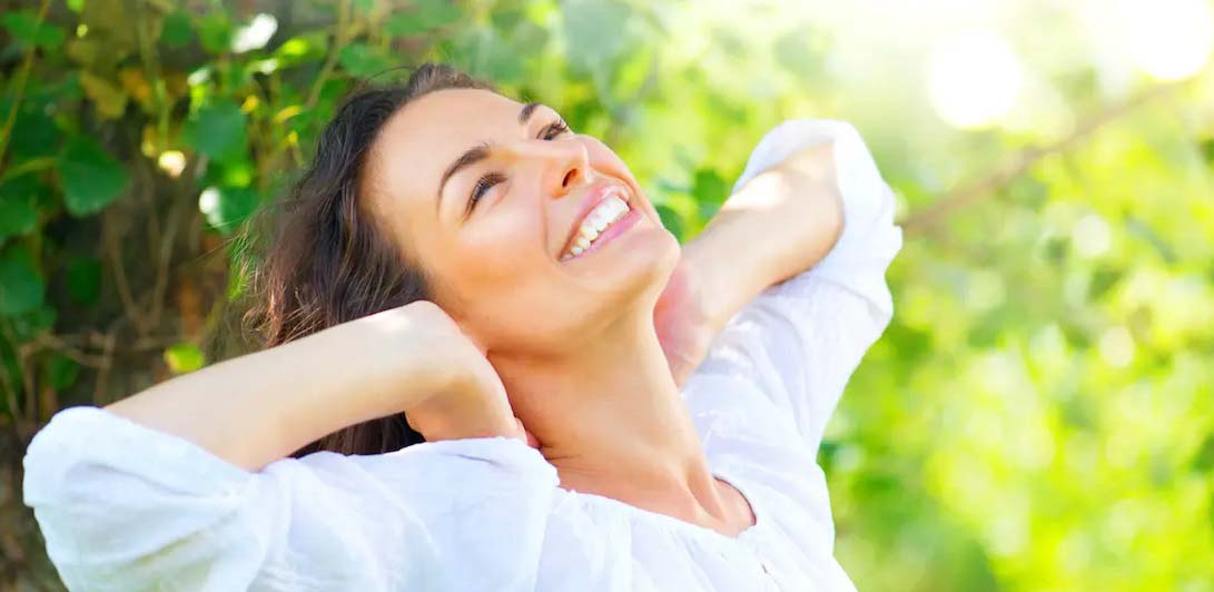 a happy woman stretching and smiling