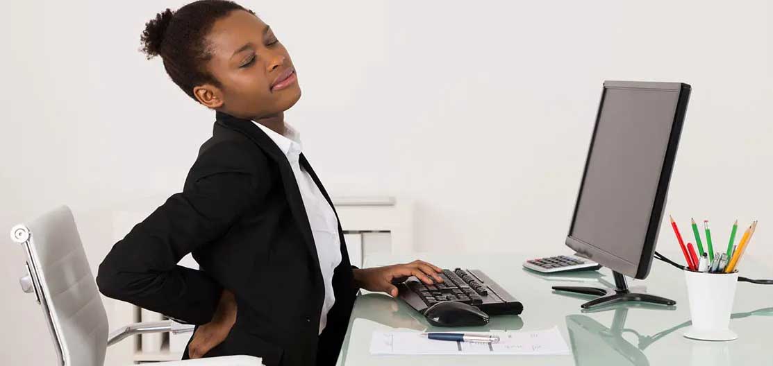 lower back pain sufferer at a desk